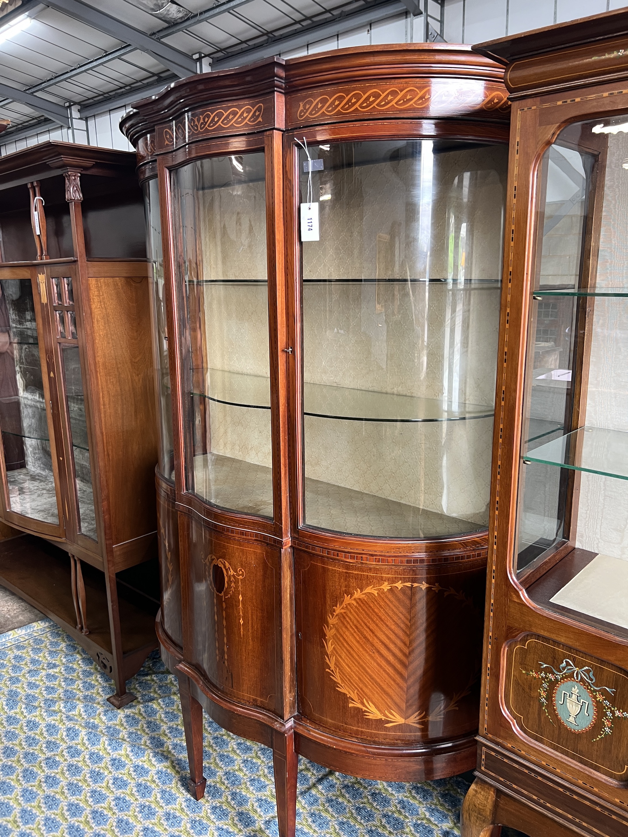 An Edwardian marquetry inlaid mahogany bowfront display cabinet, width 118cm, depth 48cm, height 185cm